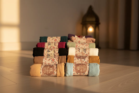 Stack of patterned socks in various colors on a white background