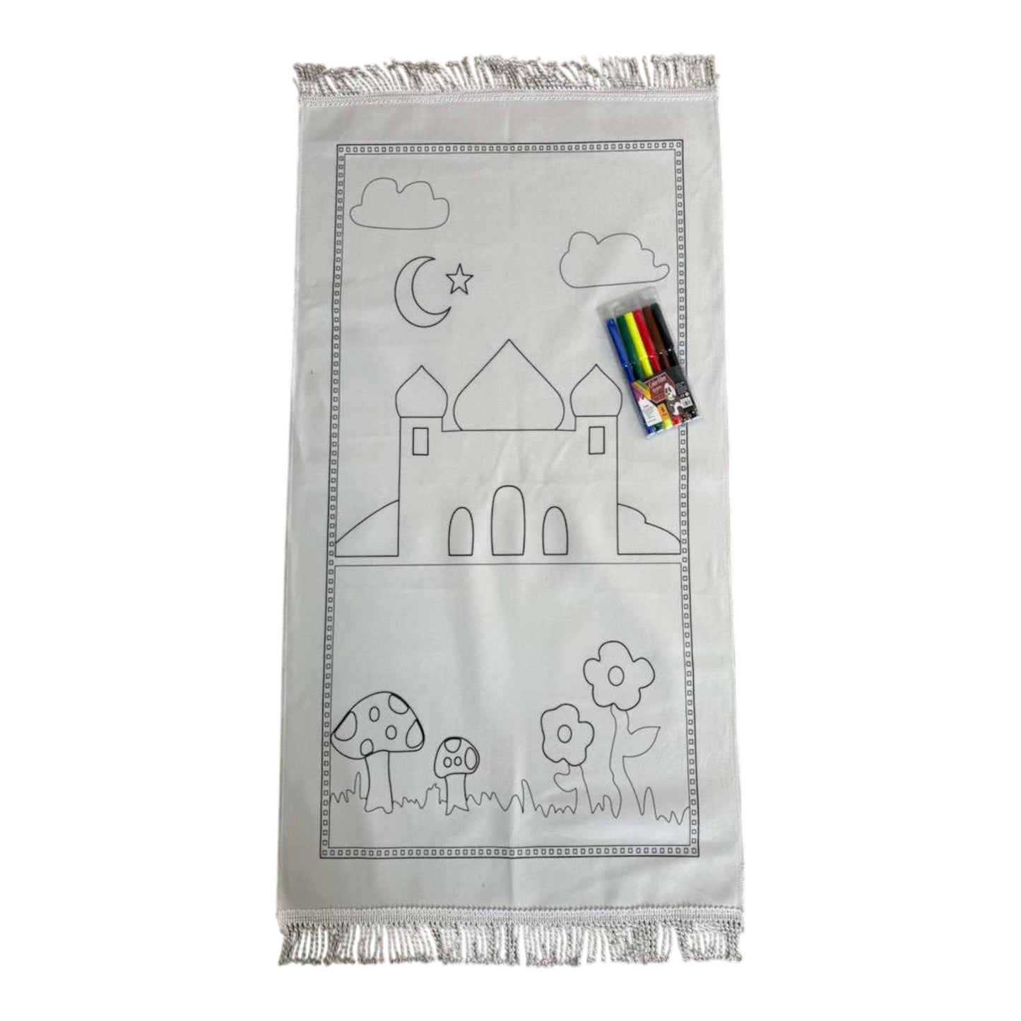 White prayer mat with black outlines of a castle, moon, stars, clouds, and flowers, accompanied by coloring books and markers.